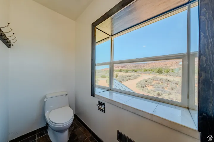 Bathroom with toilet and baseboards