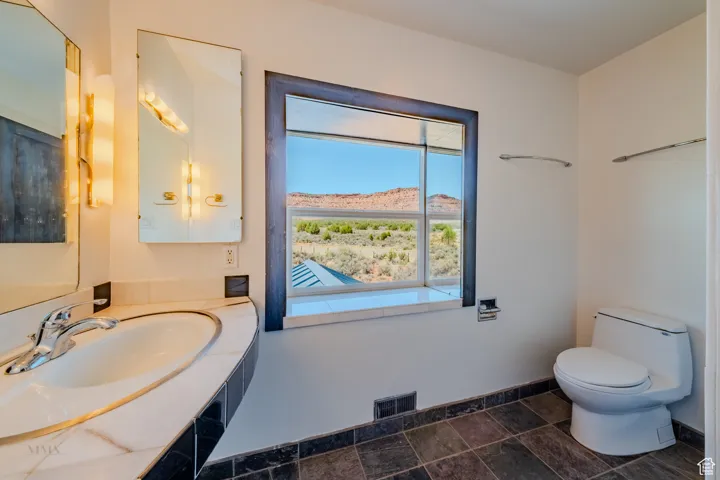 Bathroom featuring vanity, a mountain view, and stone finish flooring