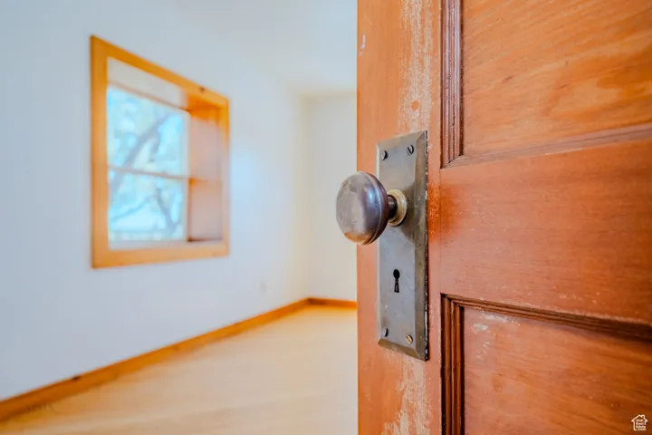 Detailed view of baseboards and wood finished floors