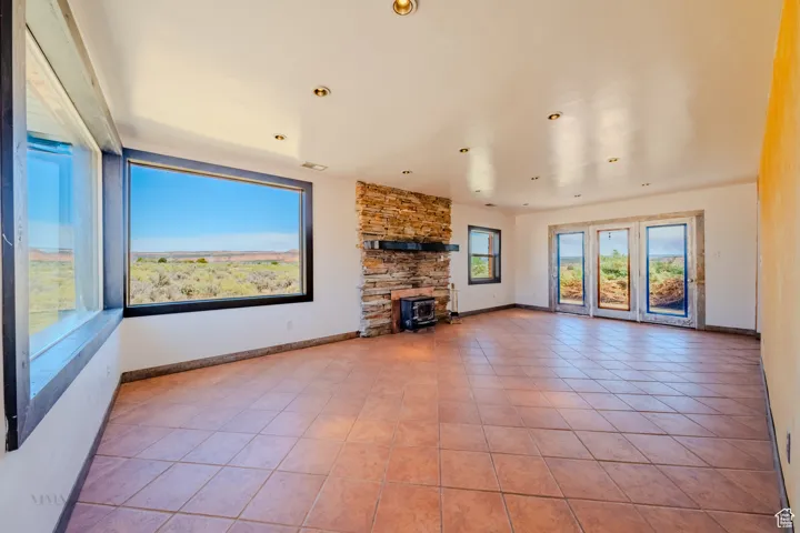 Unfurnished living room with tile patterned flooring and recessed lighting