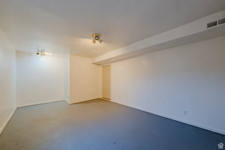 Unfurnished room featuring finished concrete floors and a textured ceiling