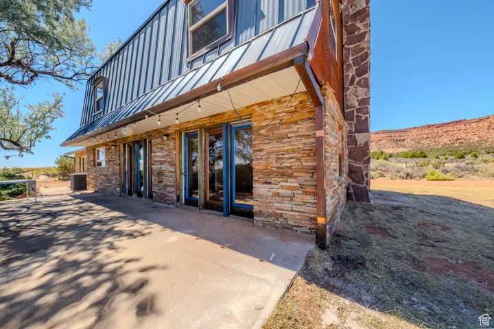 Entrance to property with a metal roof and a patio area