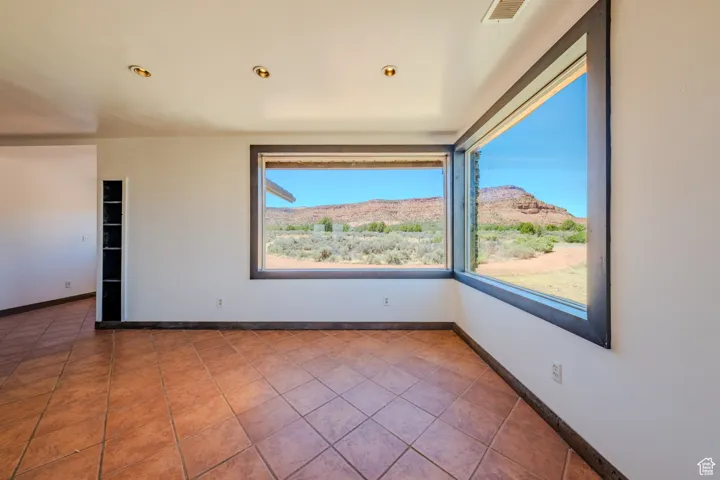 Empty room with tile patterned floors and a mountain view