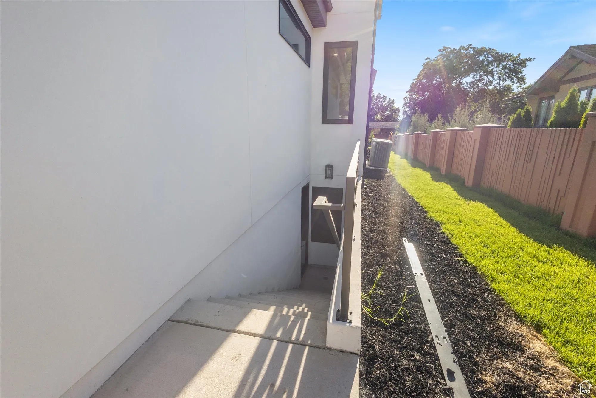 View of side of home featuring stucco siding and a central AC unit