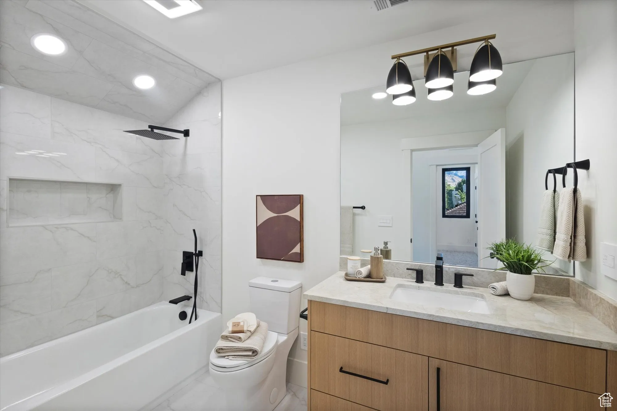 Bathroom featuring vanity, tub / shower combination, and recessed lighting