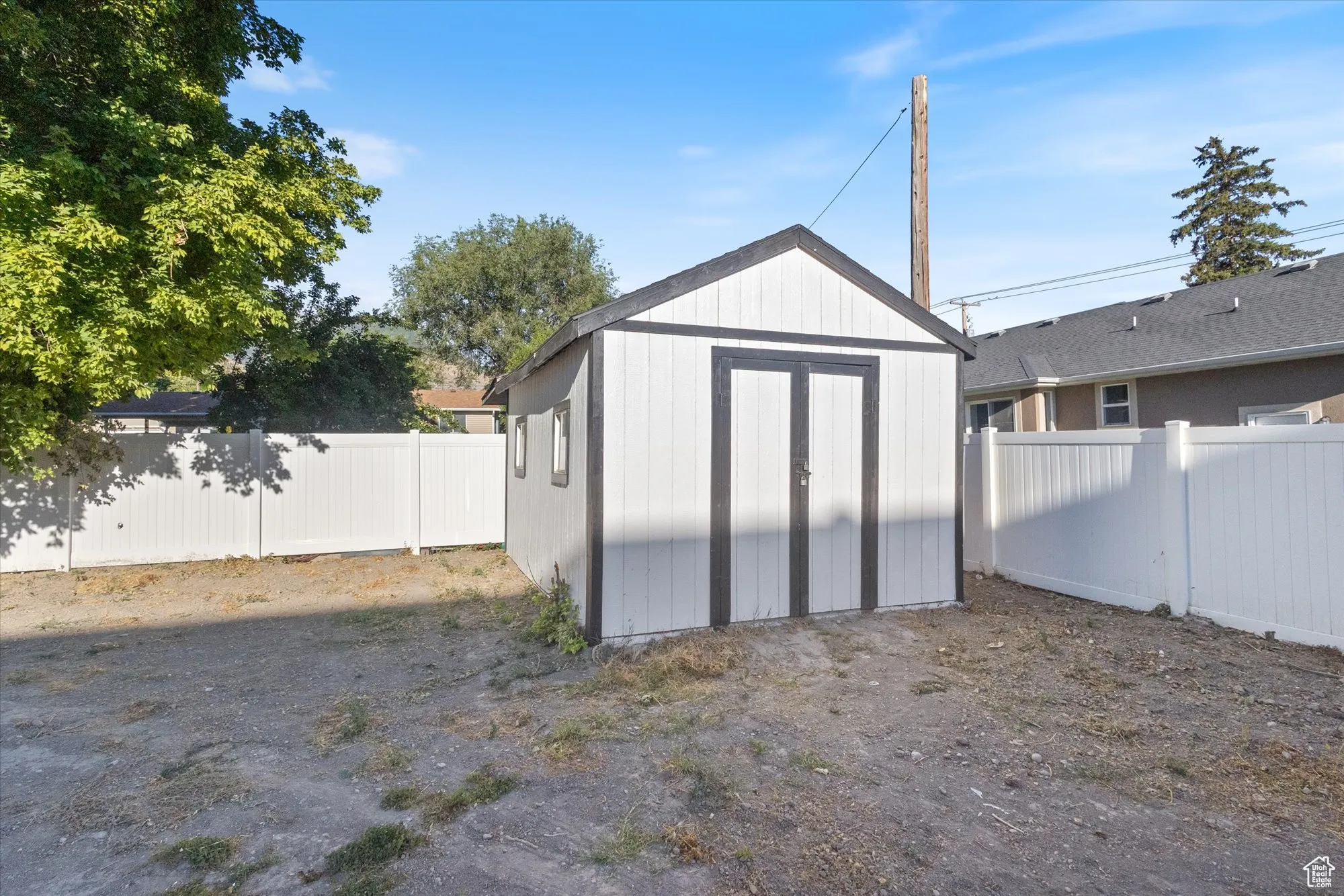 View of shed with a fenced backyard