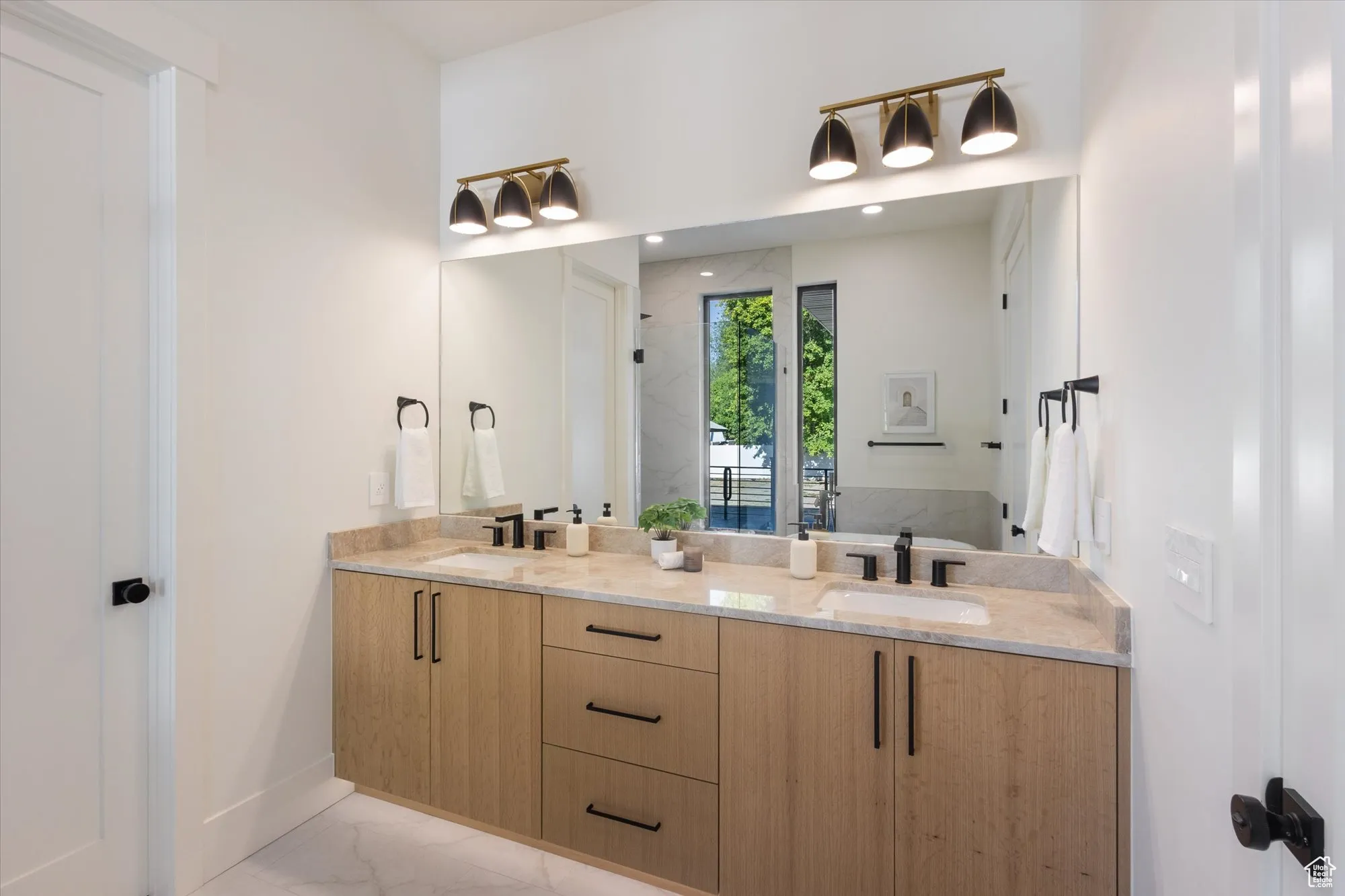 Full bathroom with double vanity and marble finish flooring
