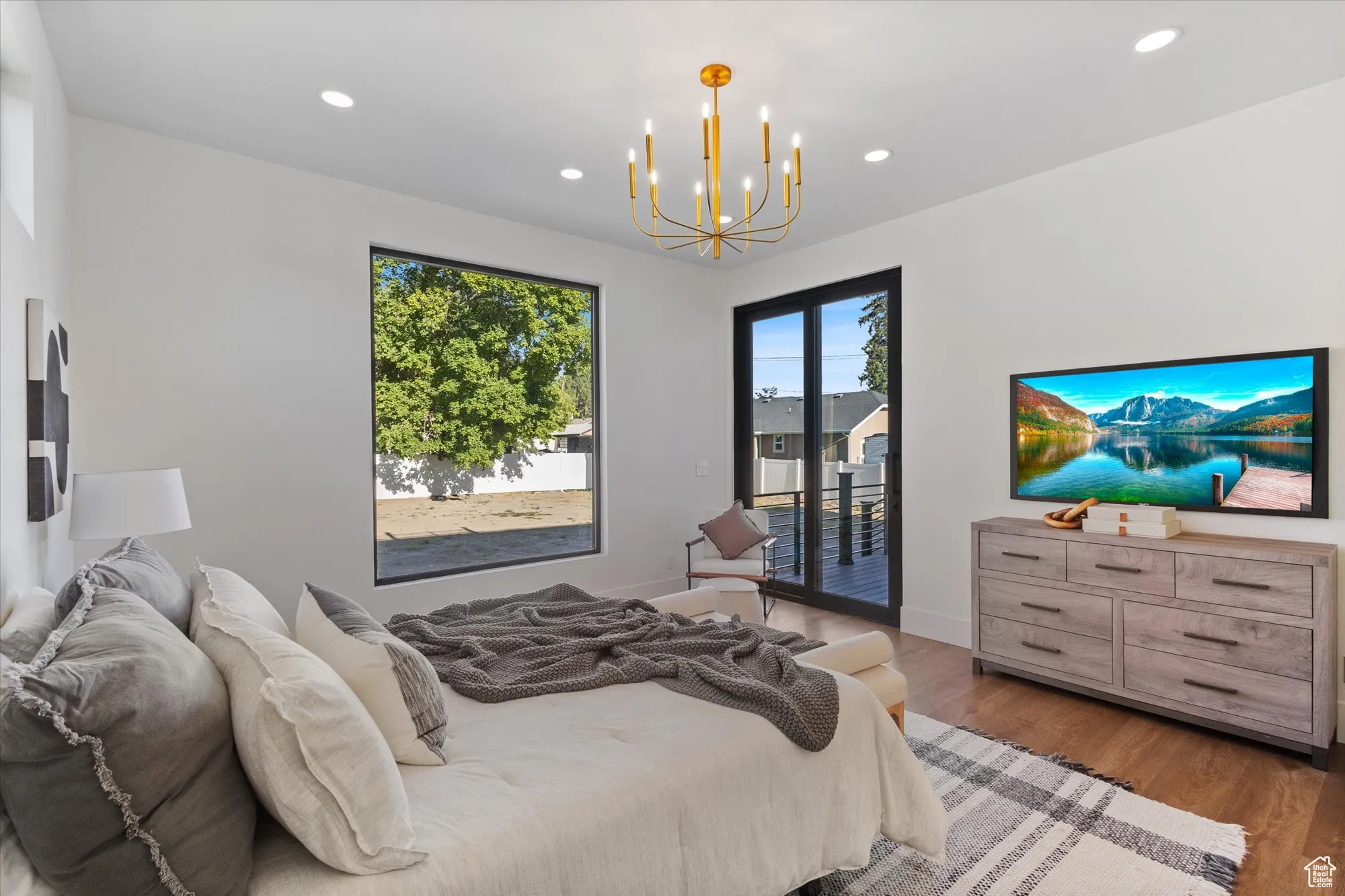 Bedroom featuring access to outside, wood finished floors, recessed lighting, and a chandelier