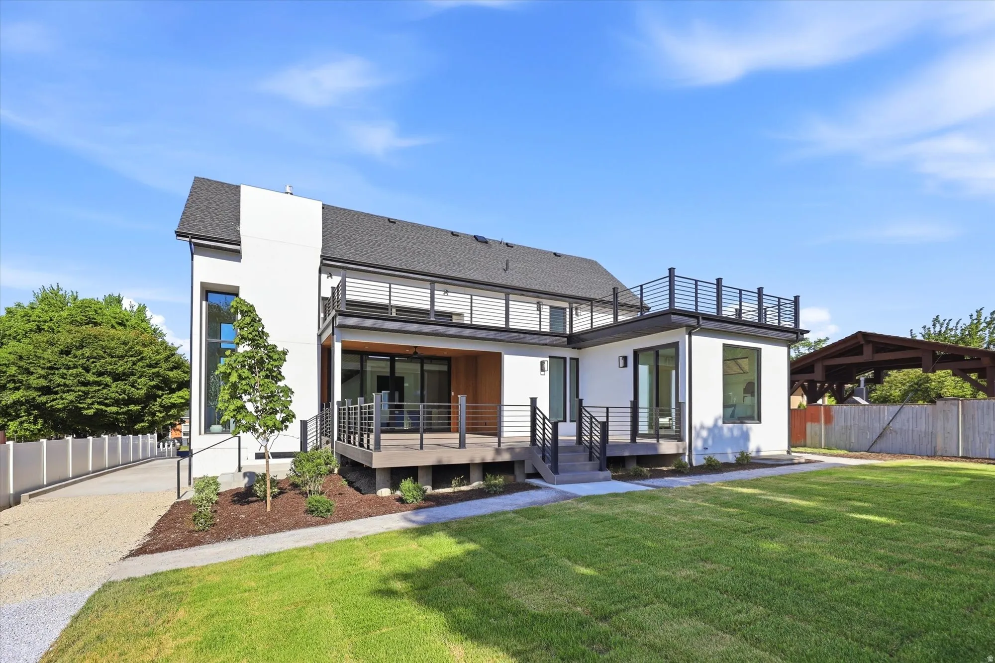 Contemporary white stucco exterior with multiple outdoor living spaces
