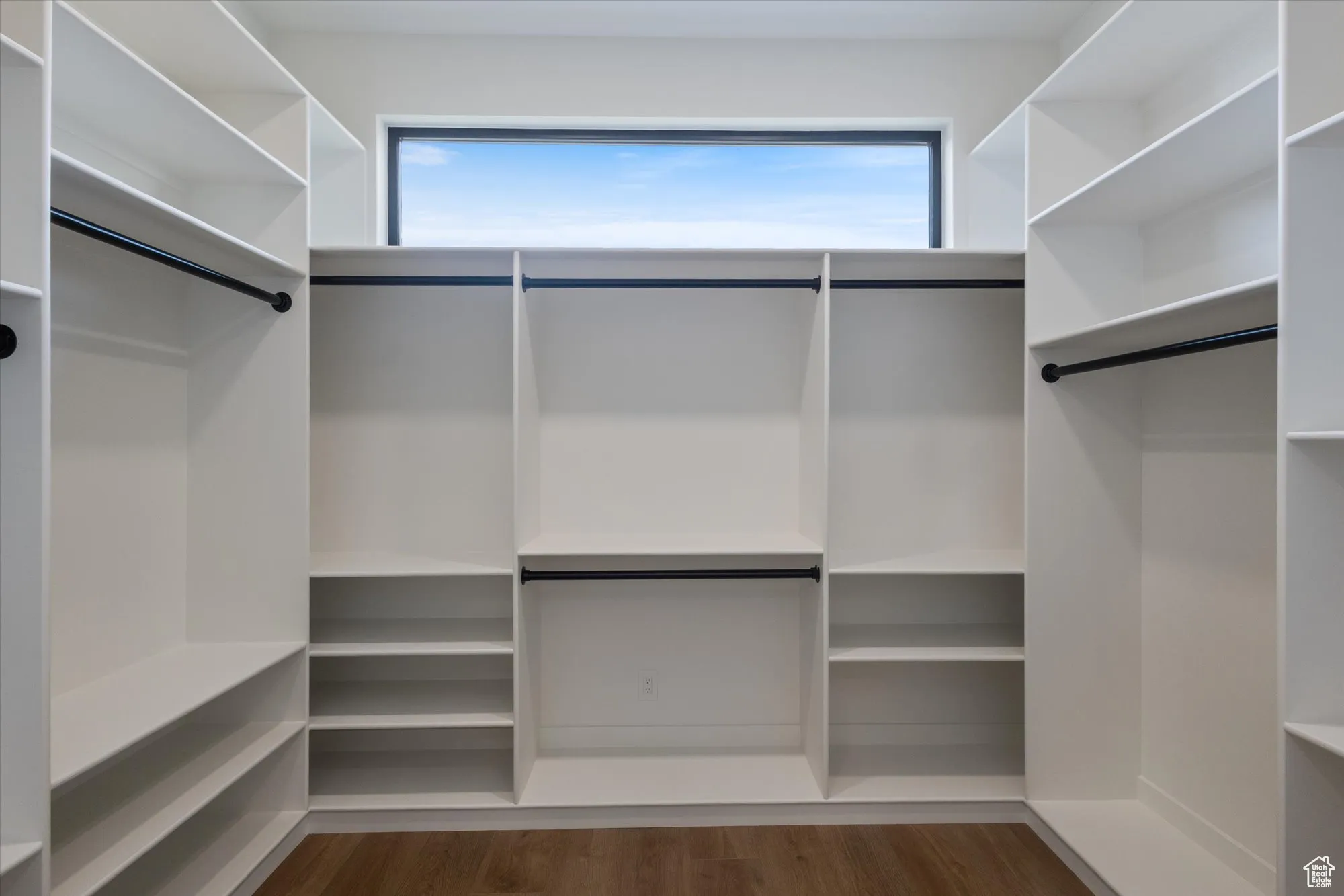 Walk in closet featuring dark wood-type flooring