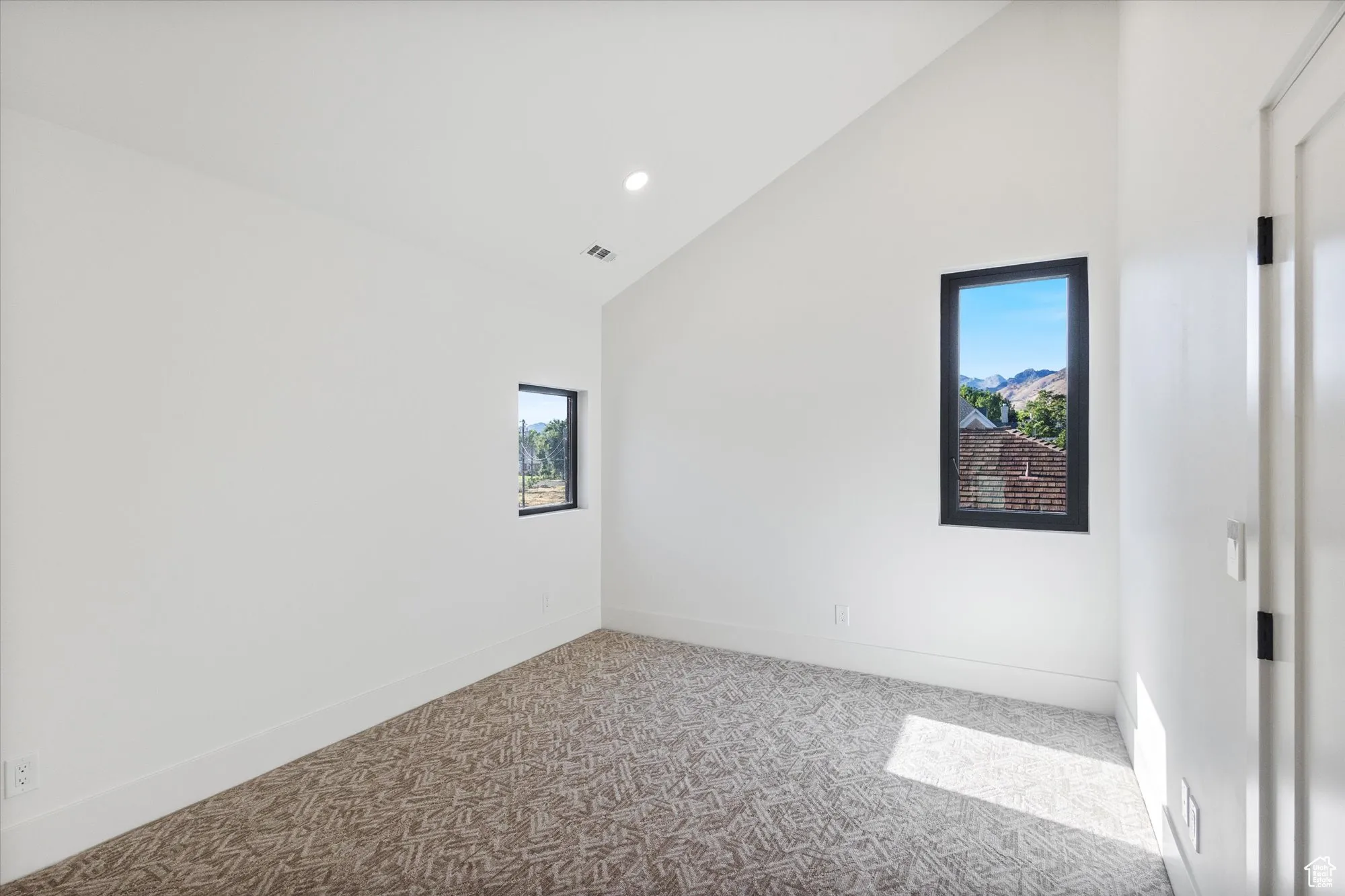 Spare room featuring carpet floors, high vaulted ceiling, and recessed lighting