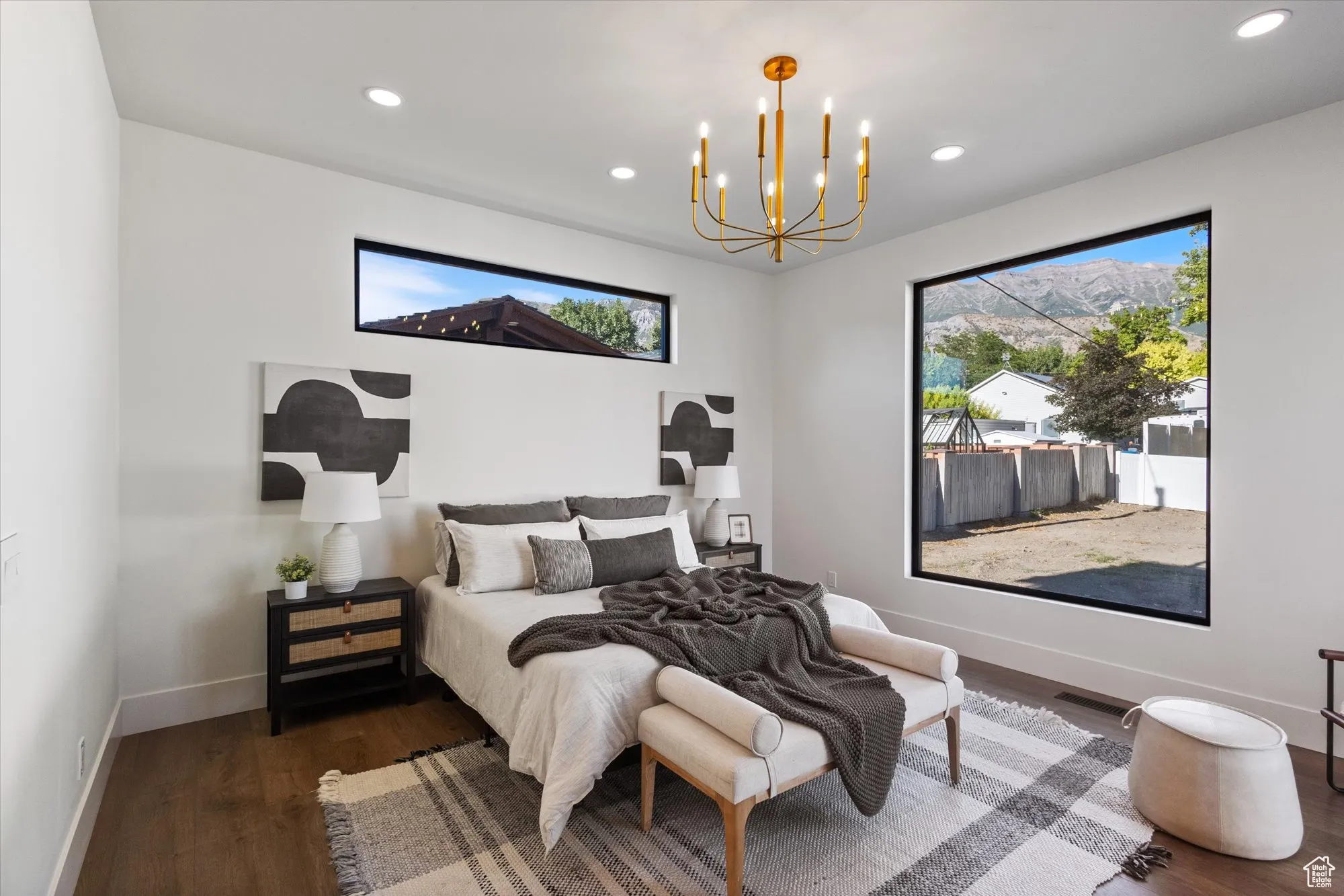 Bedroom featuring multiple windows, wood finished floors, recessed lighting, and a chandelier