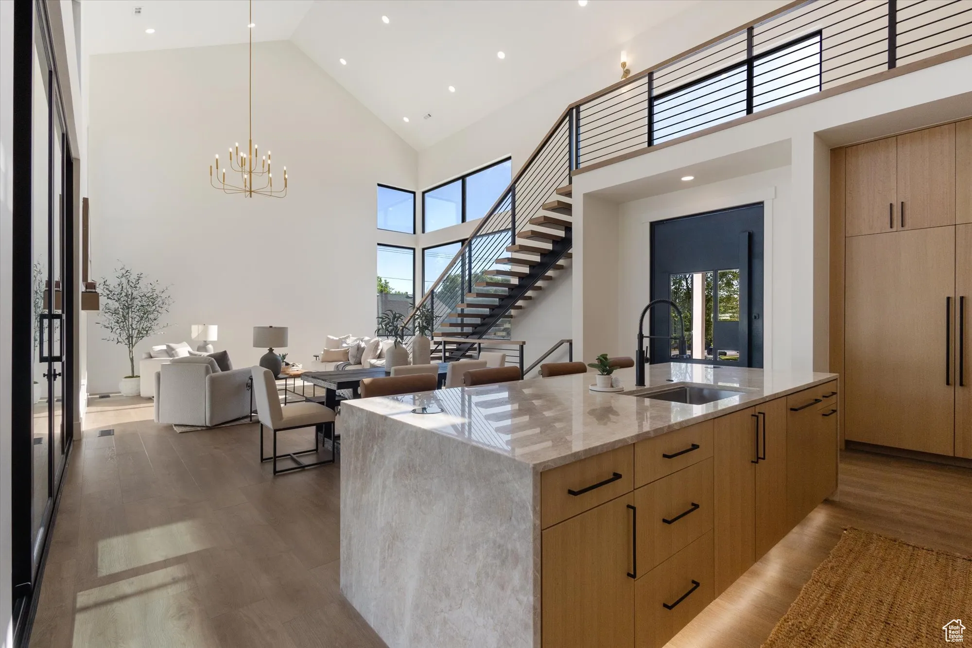 Kitchen with light brown cabinetry, modern cabinets, healthy amount of natural light, light stone countertops, and recessed lighting