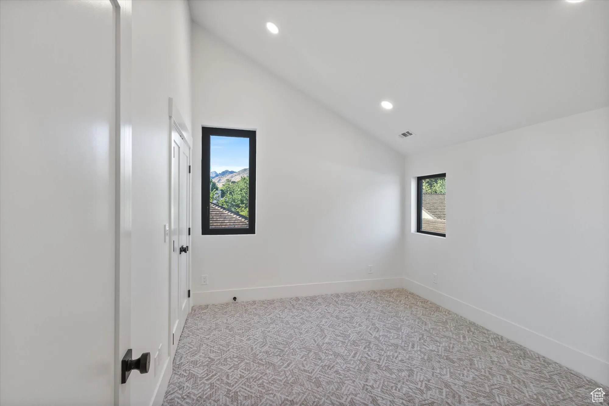 Spare room with carpet floors, recessed lighting, and high vaulted ceiling