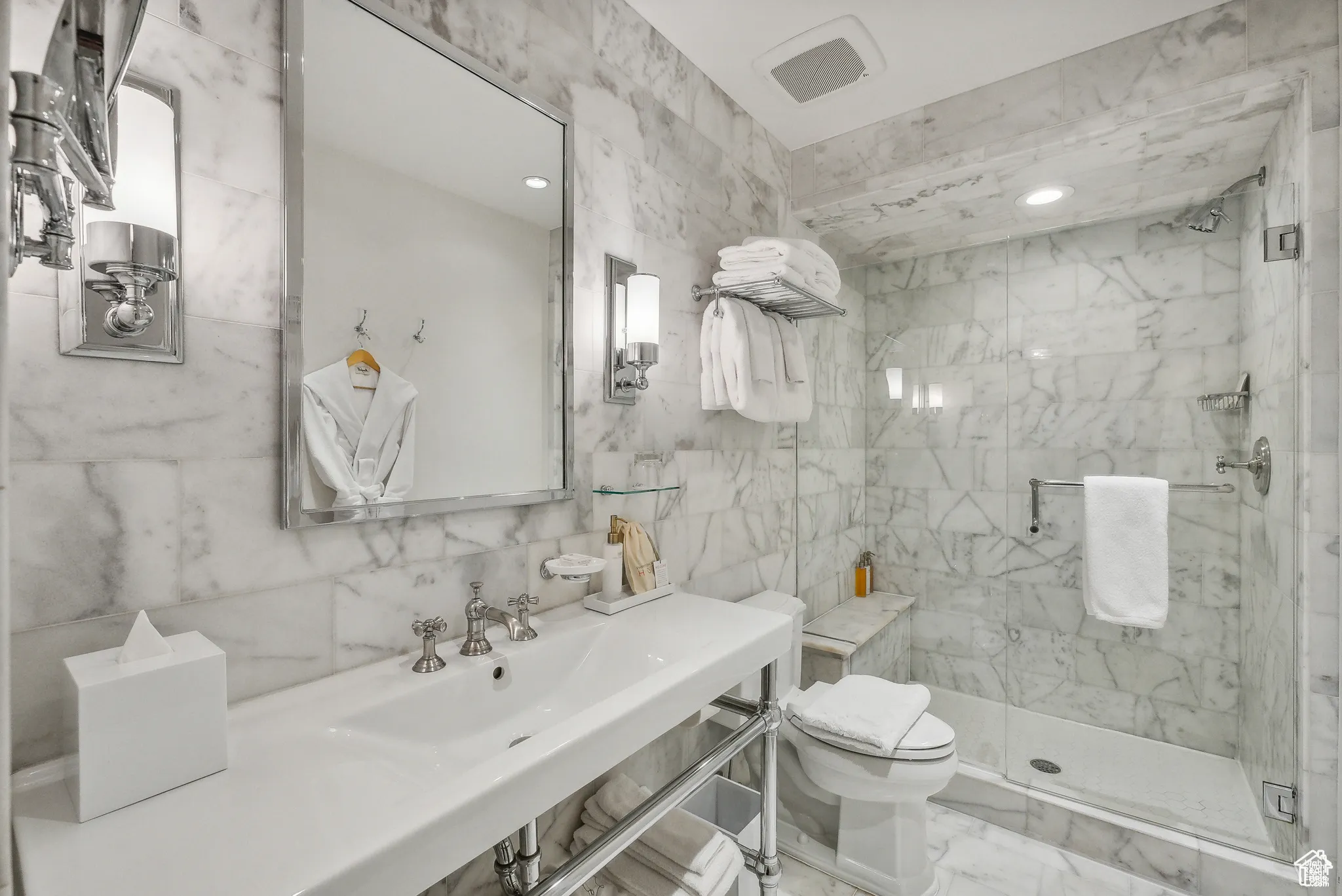 Bathroom with tile walls, a marble finish shower, marble look tiles, and recessed lighting