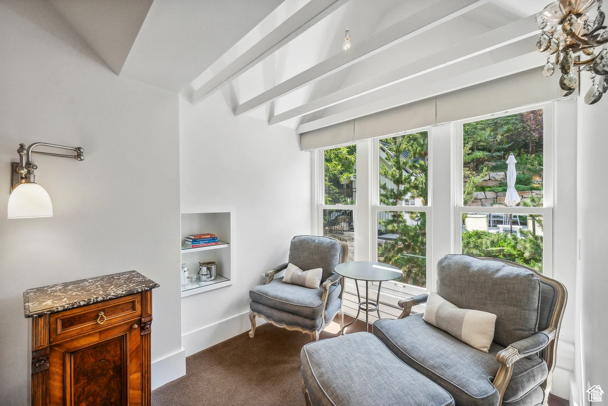 Sitting room with built in features and dark carpet