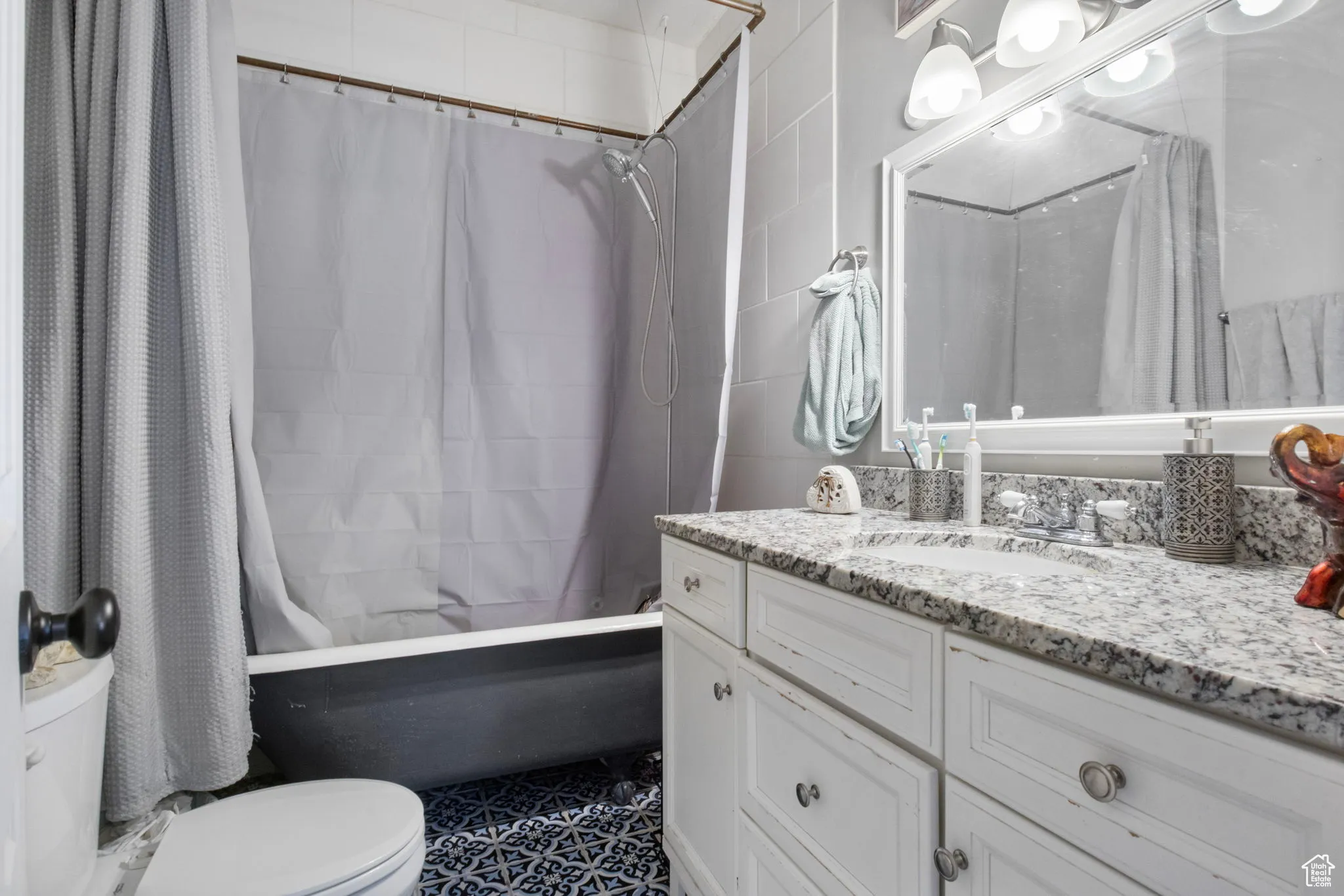 Bathroom with vanity and shower / tub combo