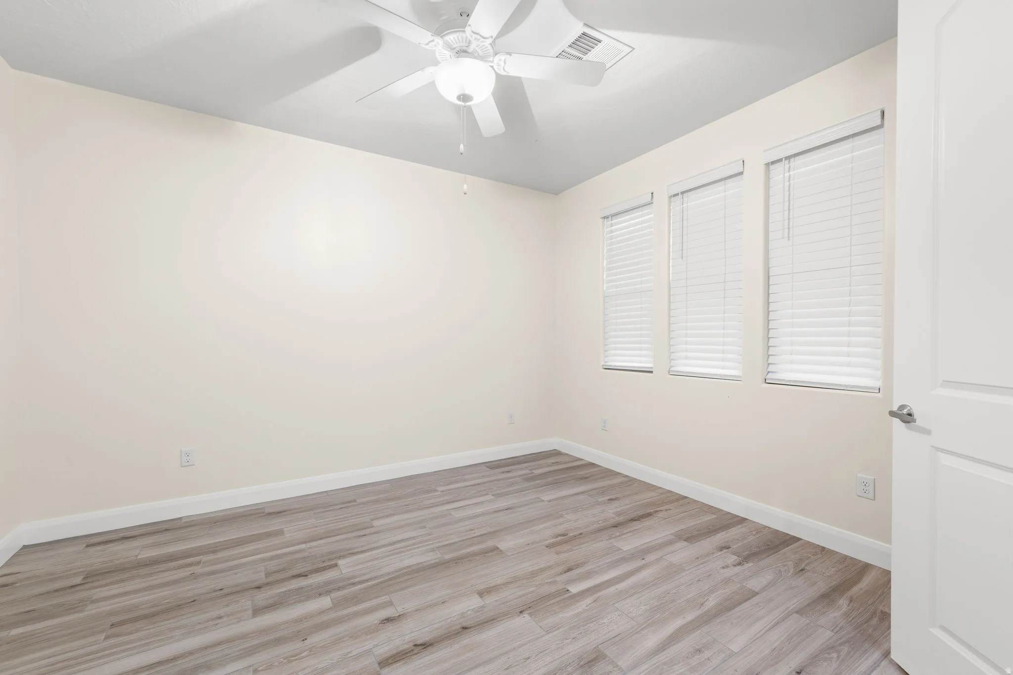 Unfurnished bedroom with light wood-style floors and ceiling fan