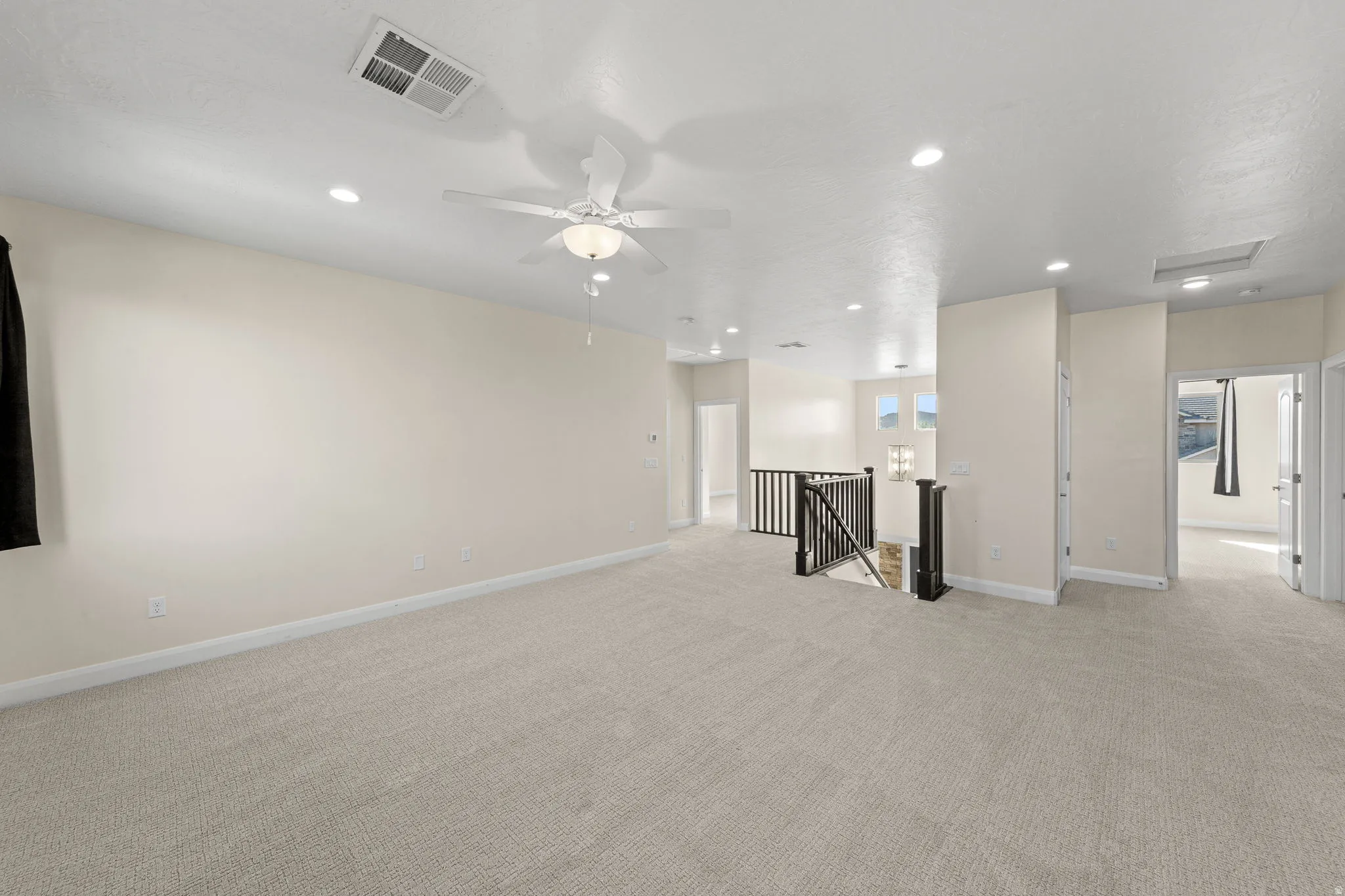 Unfurnished living room with light carpet and recessed lighting
