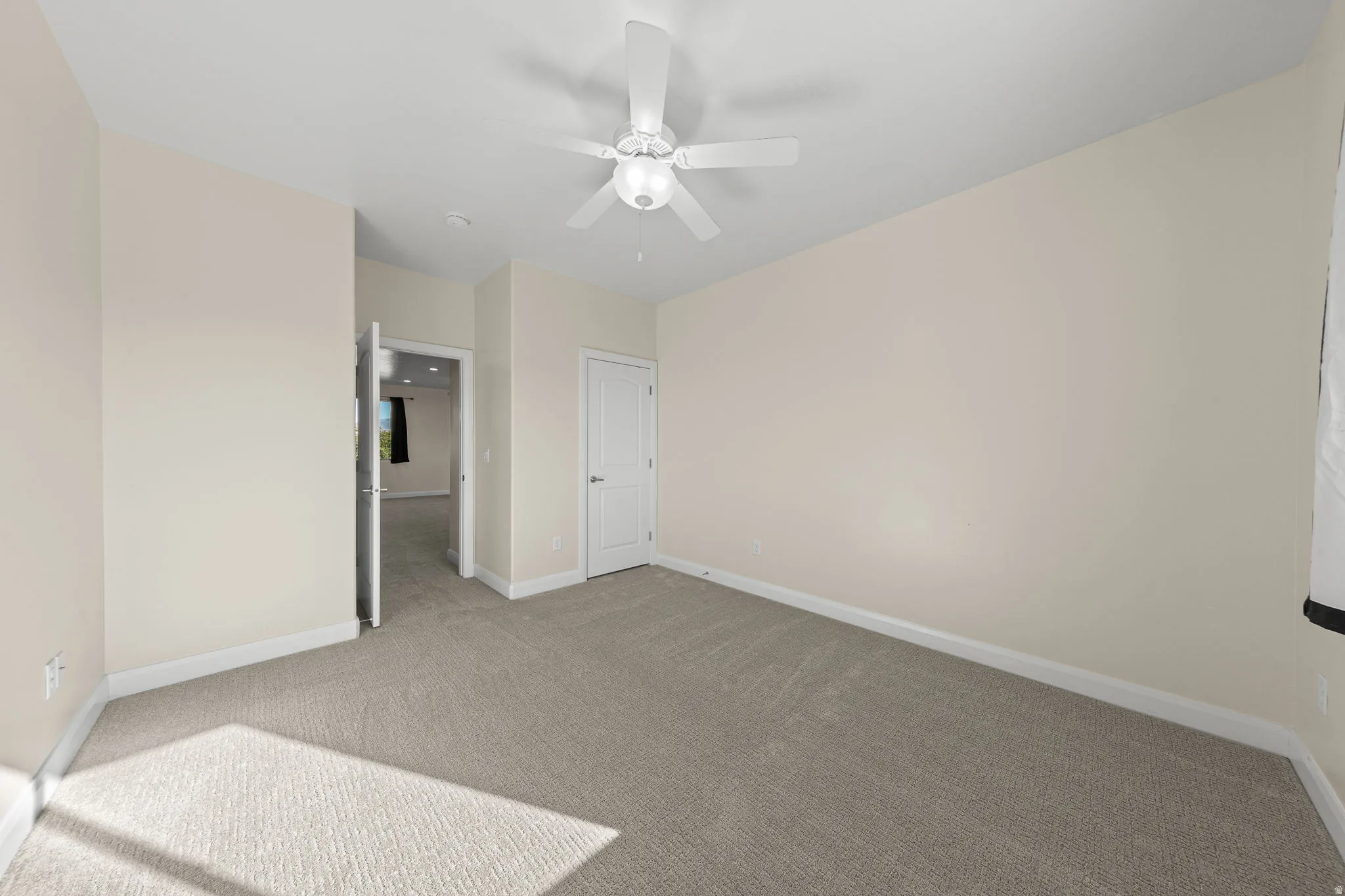 Unfurnished bedroom featuring carpet floors and ceiling fan
