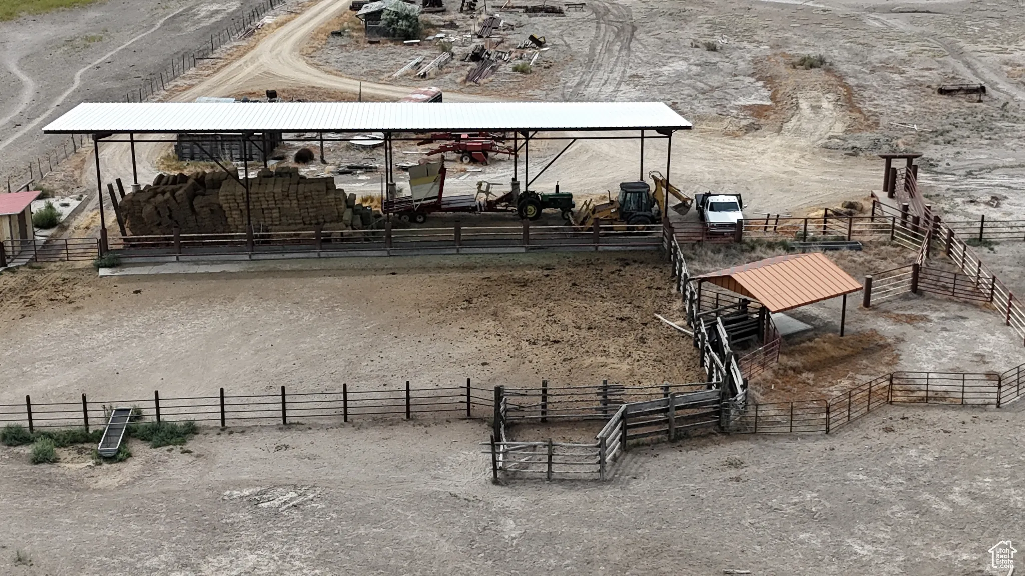 View of community featuring a rural view, a horse riding arena, and an exterior structure