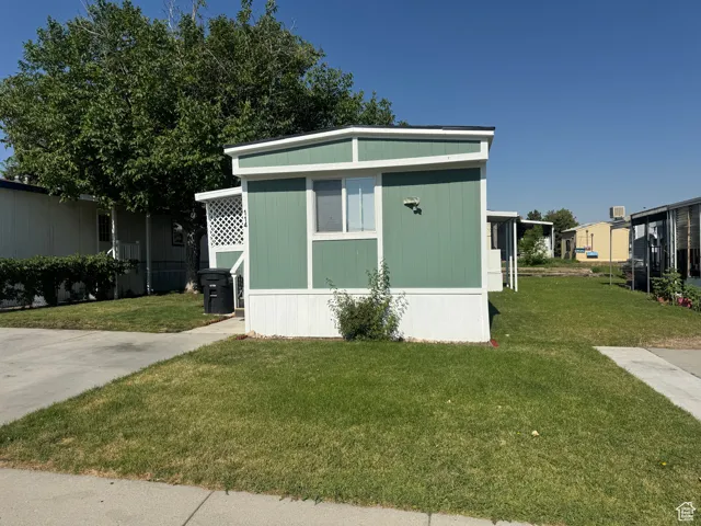 View of side of home featuring a lawn