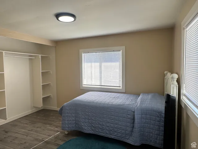 Bedroom featuring wood finished floors and baseboards