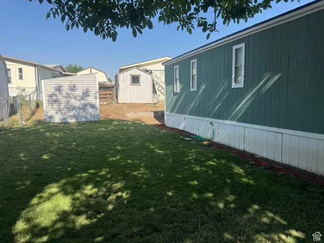 View of yard with a storage unit
