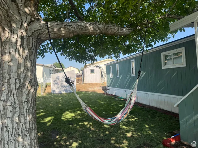 View of yard featuring a storage shed and a residential view