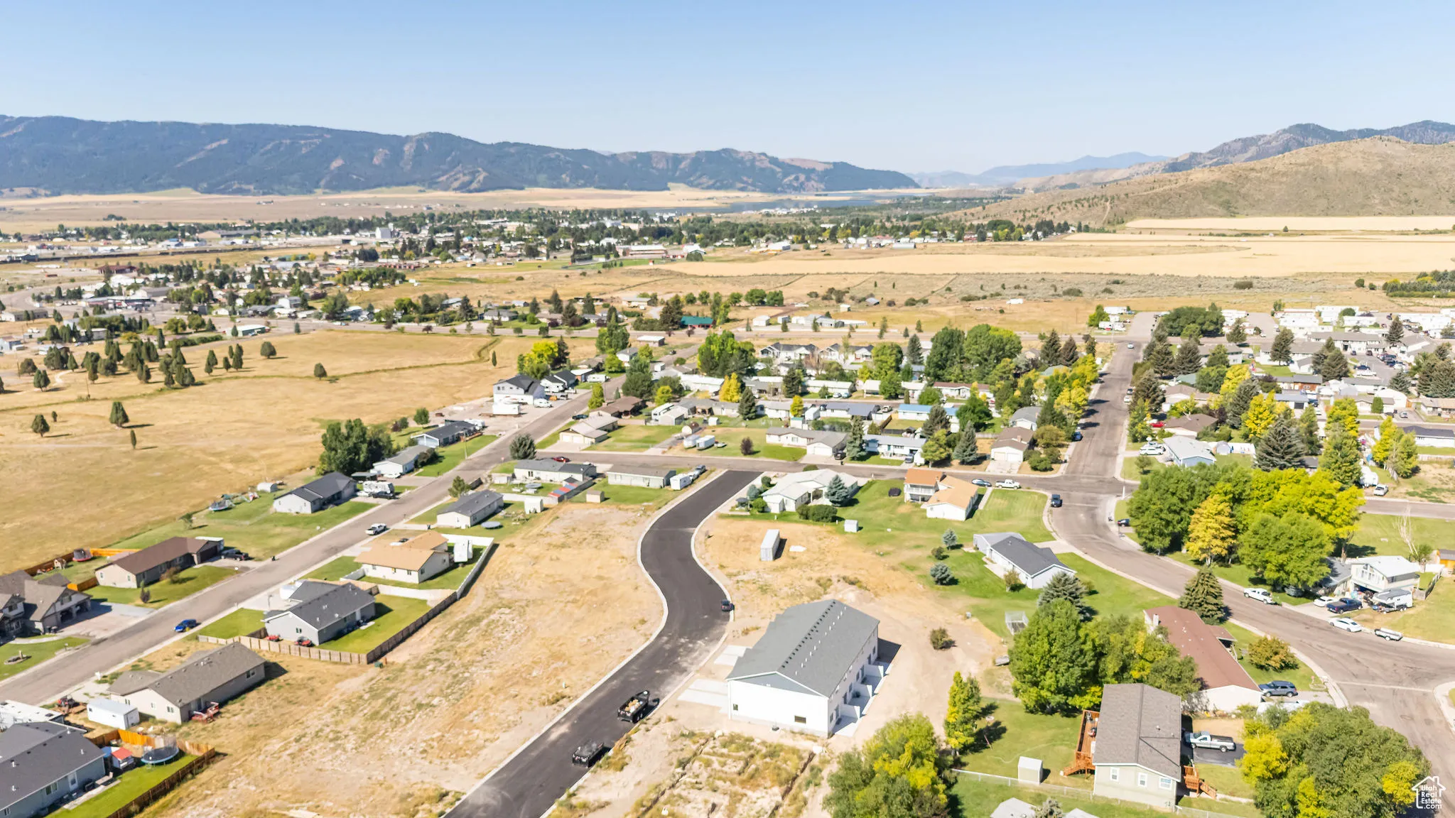 Aerial view of property's location with nearby suburban area and mountains