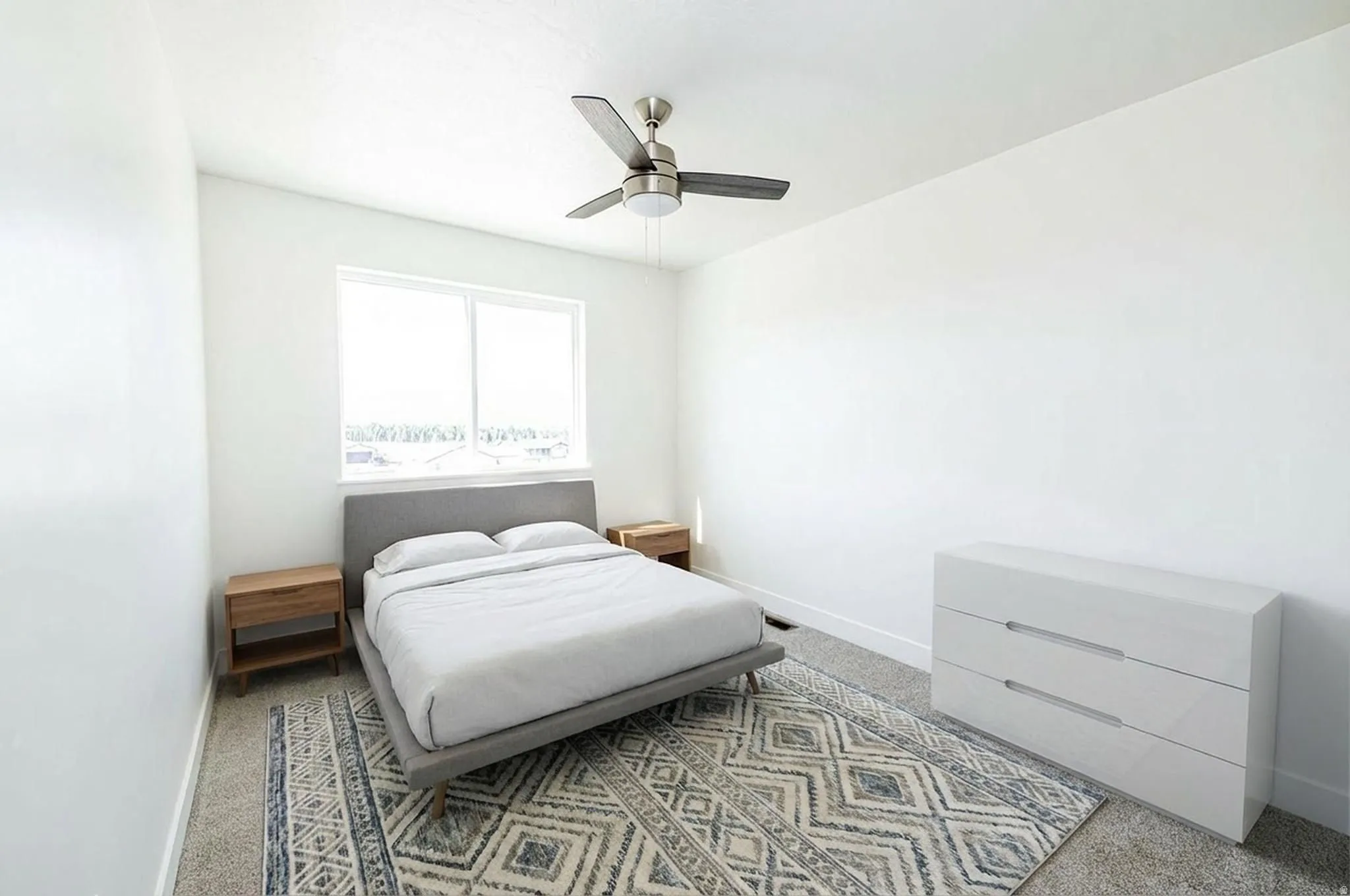 Bedroom featuring ceiling fan and light colored carpet