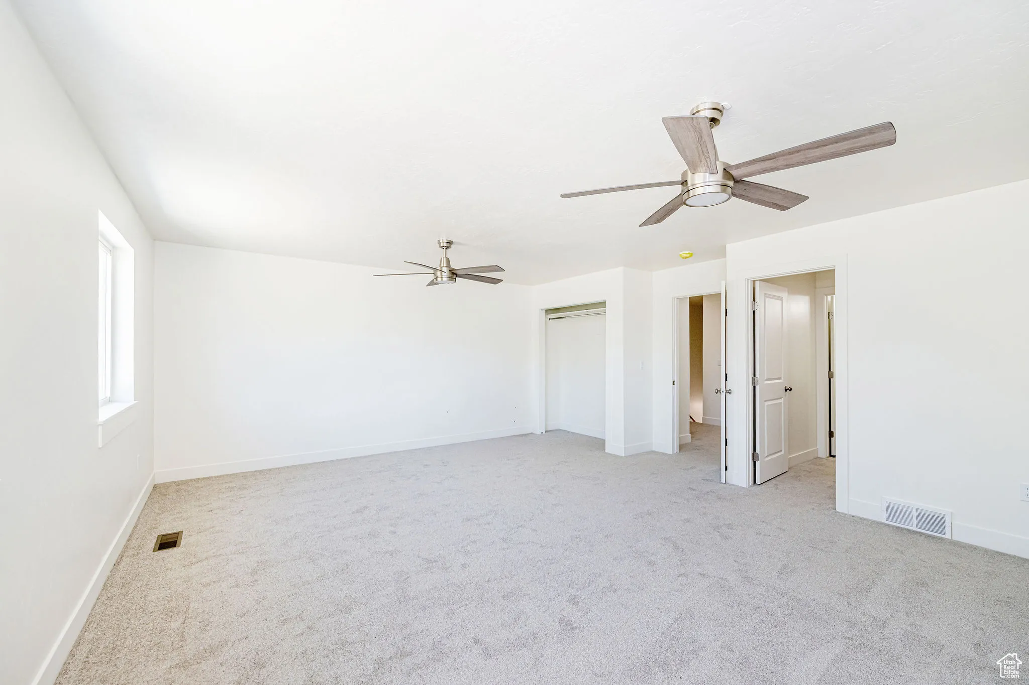 Unfurnished bedroom featuring carpet, a closet, and a ceiling fan