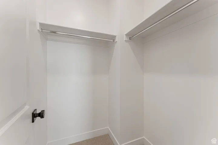 Walk in closet featuring carpet