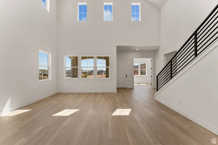 Foyer entrance featuring light wood-style floors and stairway