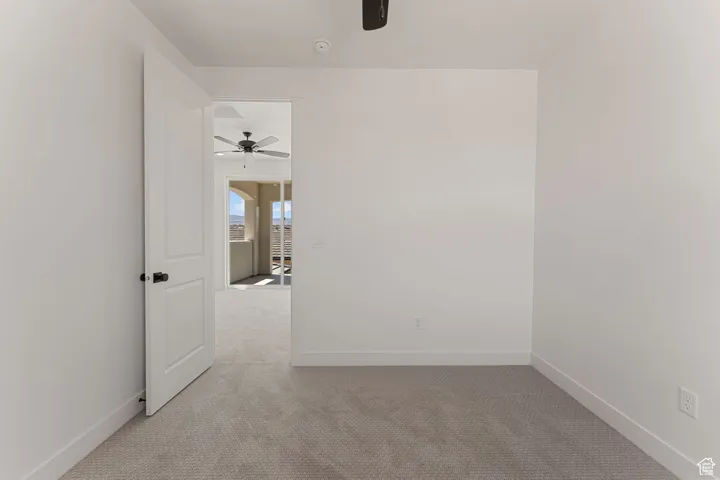 Spare room with carpet floors and a ceiling fan