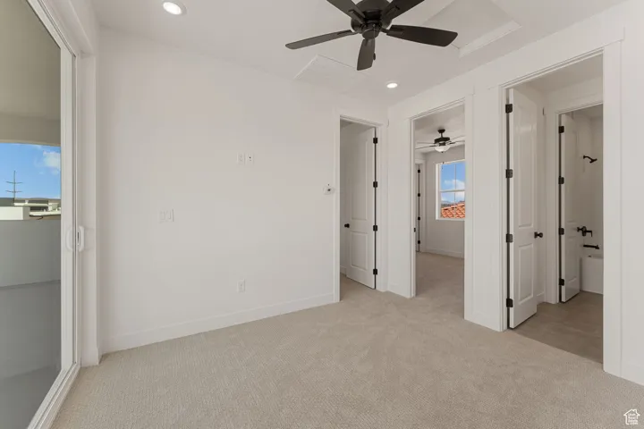 Unfurnished bedroom with light carpet, recessed lighting, ceiling fan, and attic access