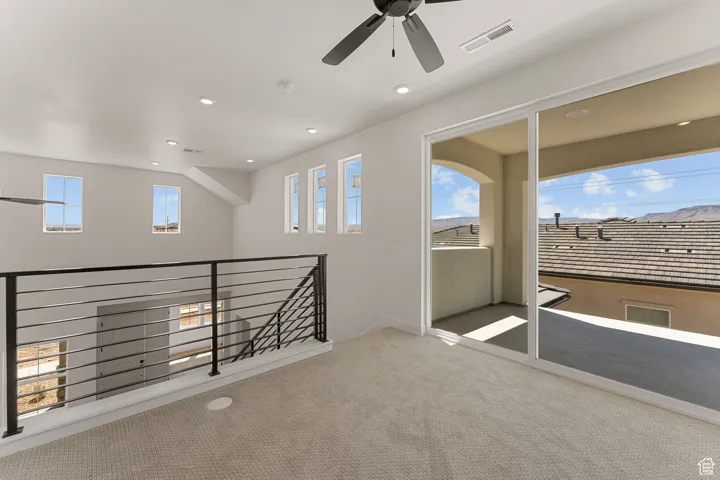 Carpeted empty room with recessed lighting and a ceiling fan