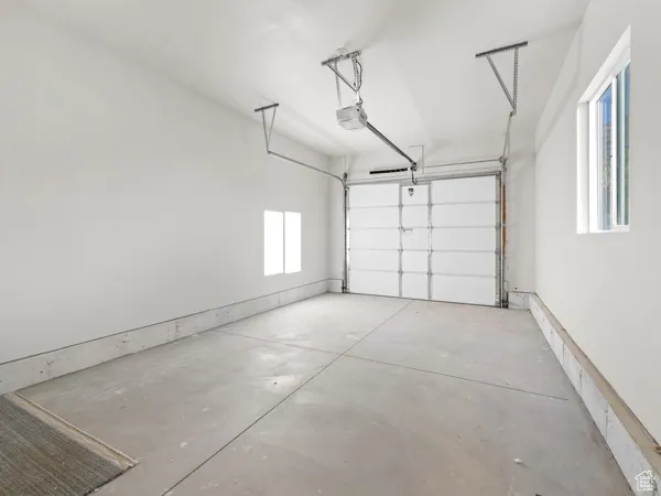 Garage featuring a garage door opener