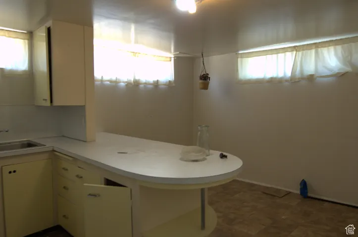 Bathroom with a sink and baseboards