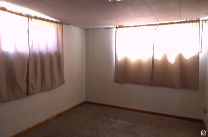 Empty room featuring carpet floors and baseboards