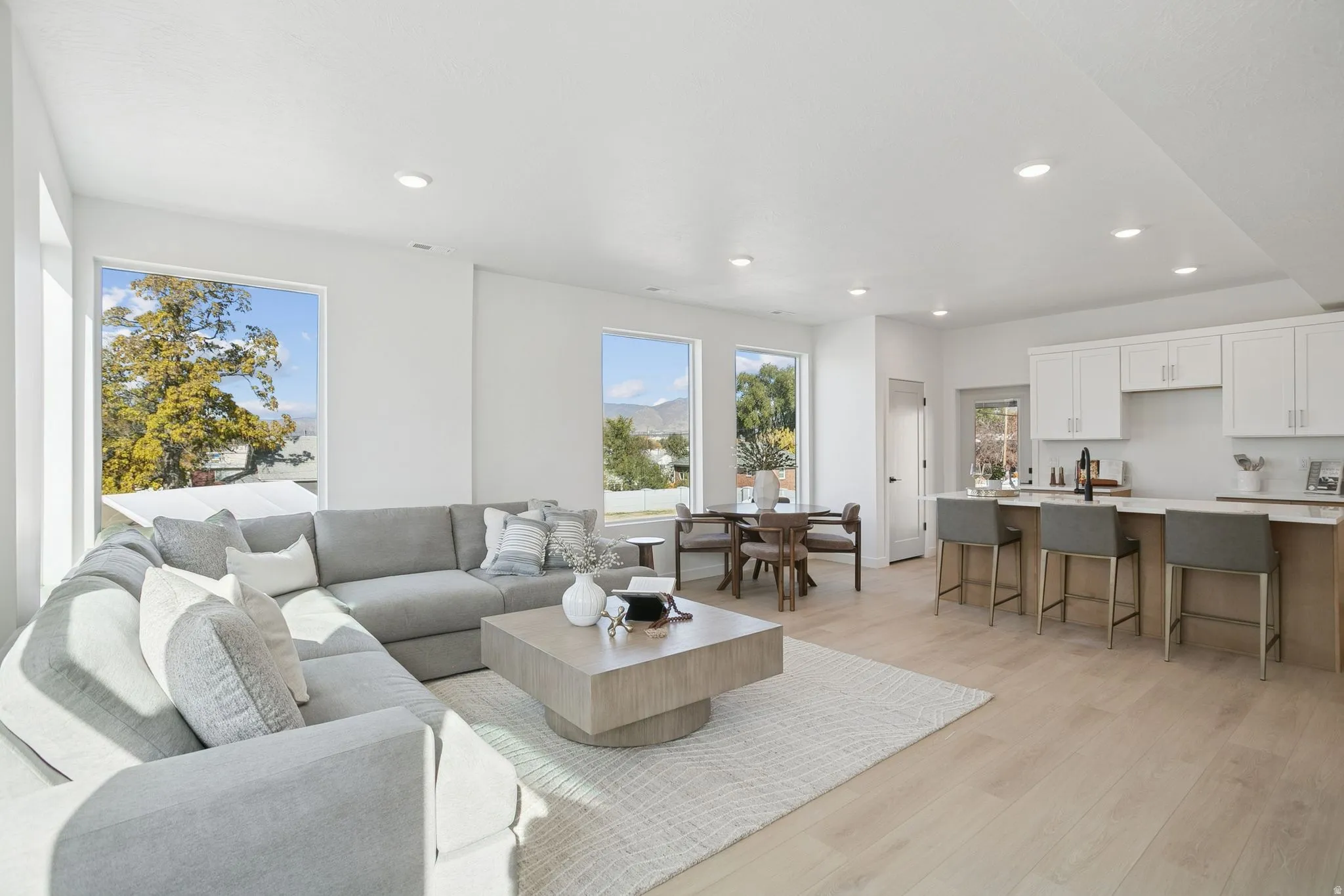 Living room with light wood-style floors and recessed lighting