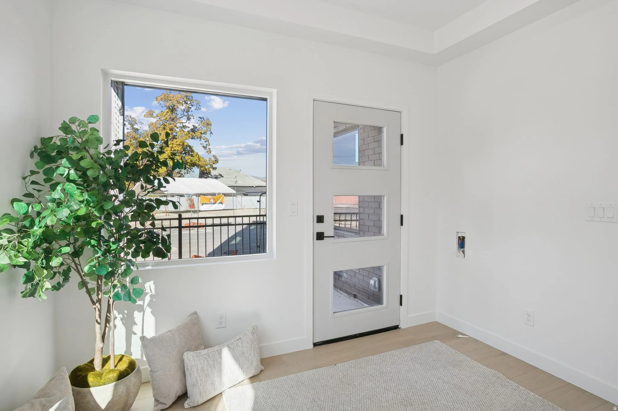 Doorway to outside with wood finished floors