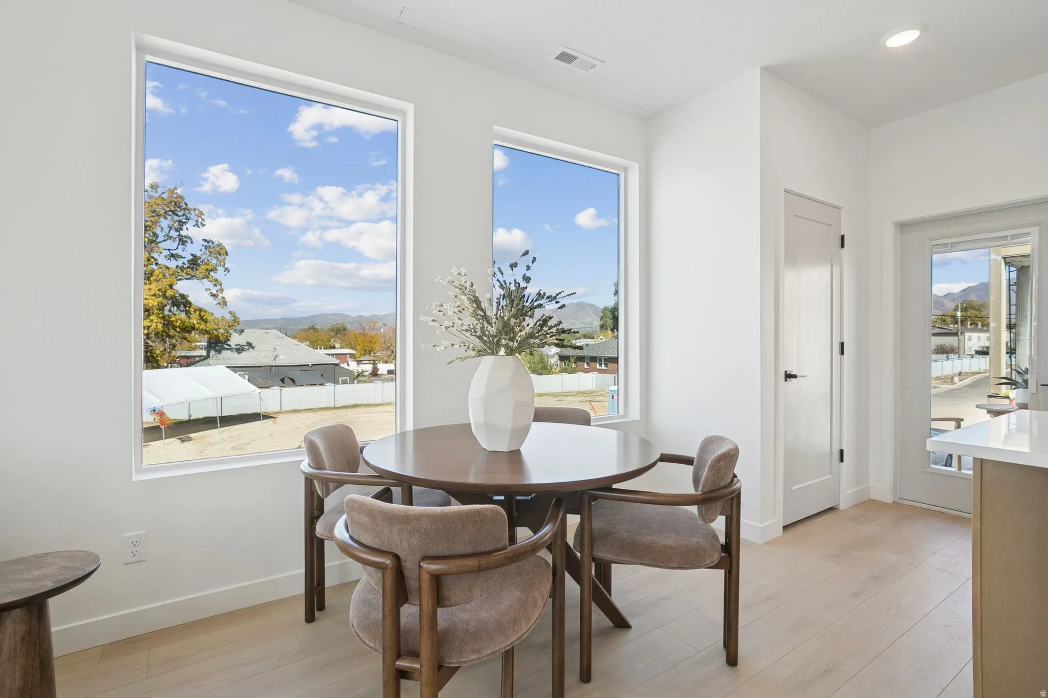Dining space featuring light wood-style flooring, a mountain view, and recessed lighting