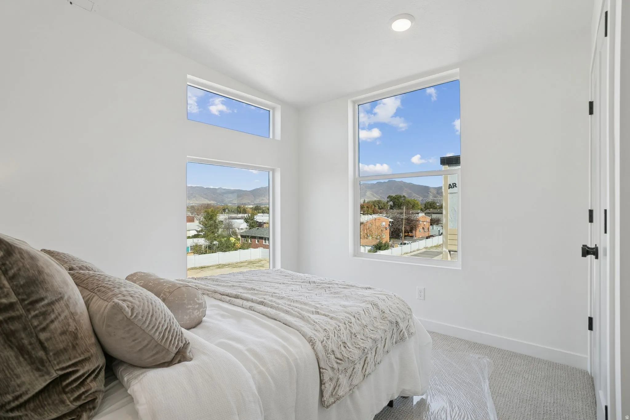Bedroom featuring a mountain view, carpet, multiple windows, and recessed lighting