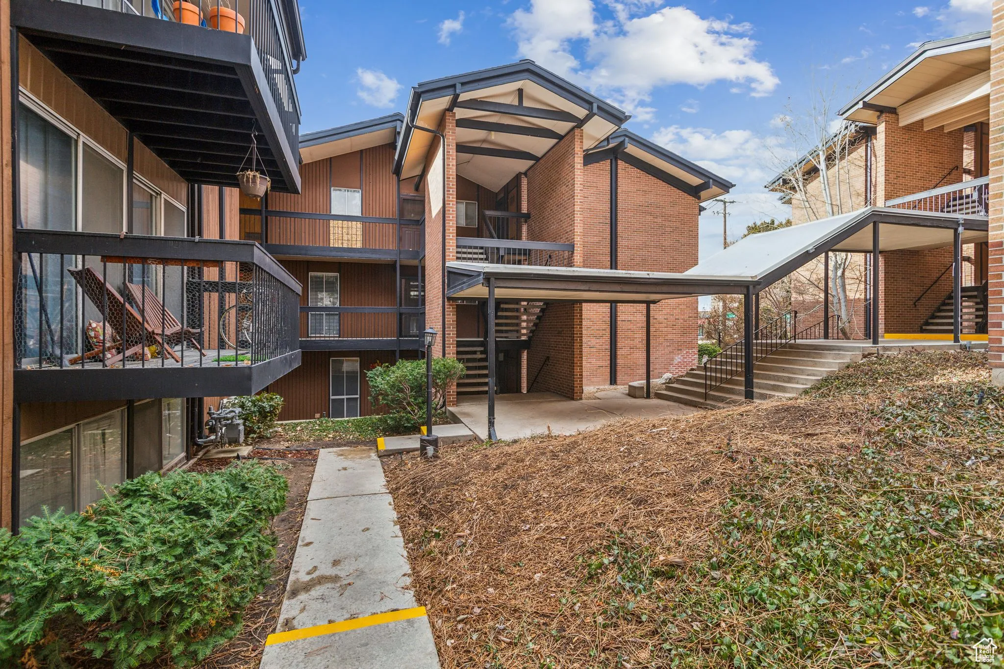 Back of property with stairs and a patio
