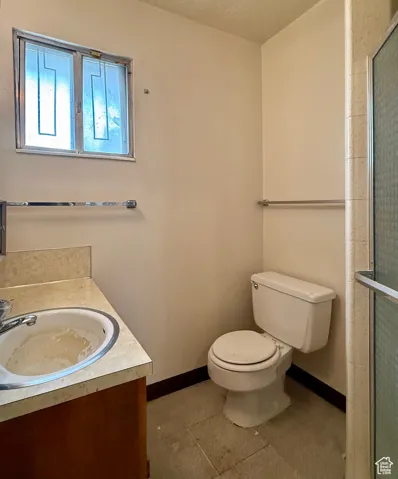Full bathroom with vanity and tiled shower