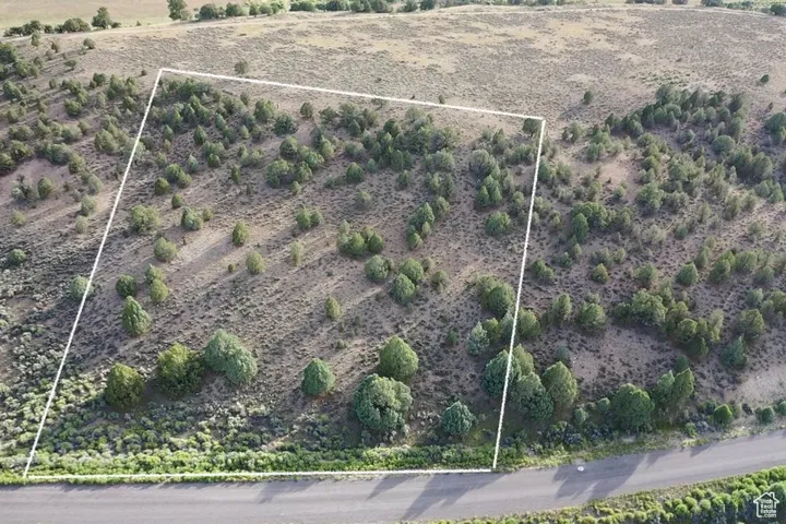 Aerial overview of property's location featuring property parcel outlined and rural landscape