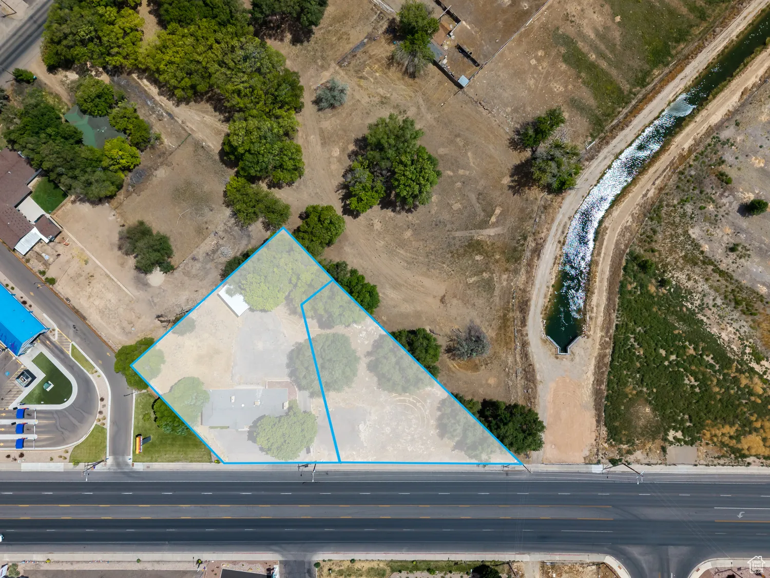 Aerial view of property's location featuring property parcel outlined and building next door