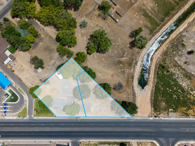 Aerial view of property's location featuring property parcel outlined and building next door