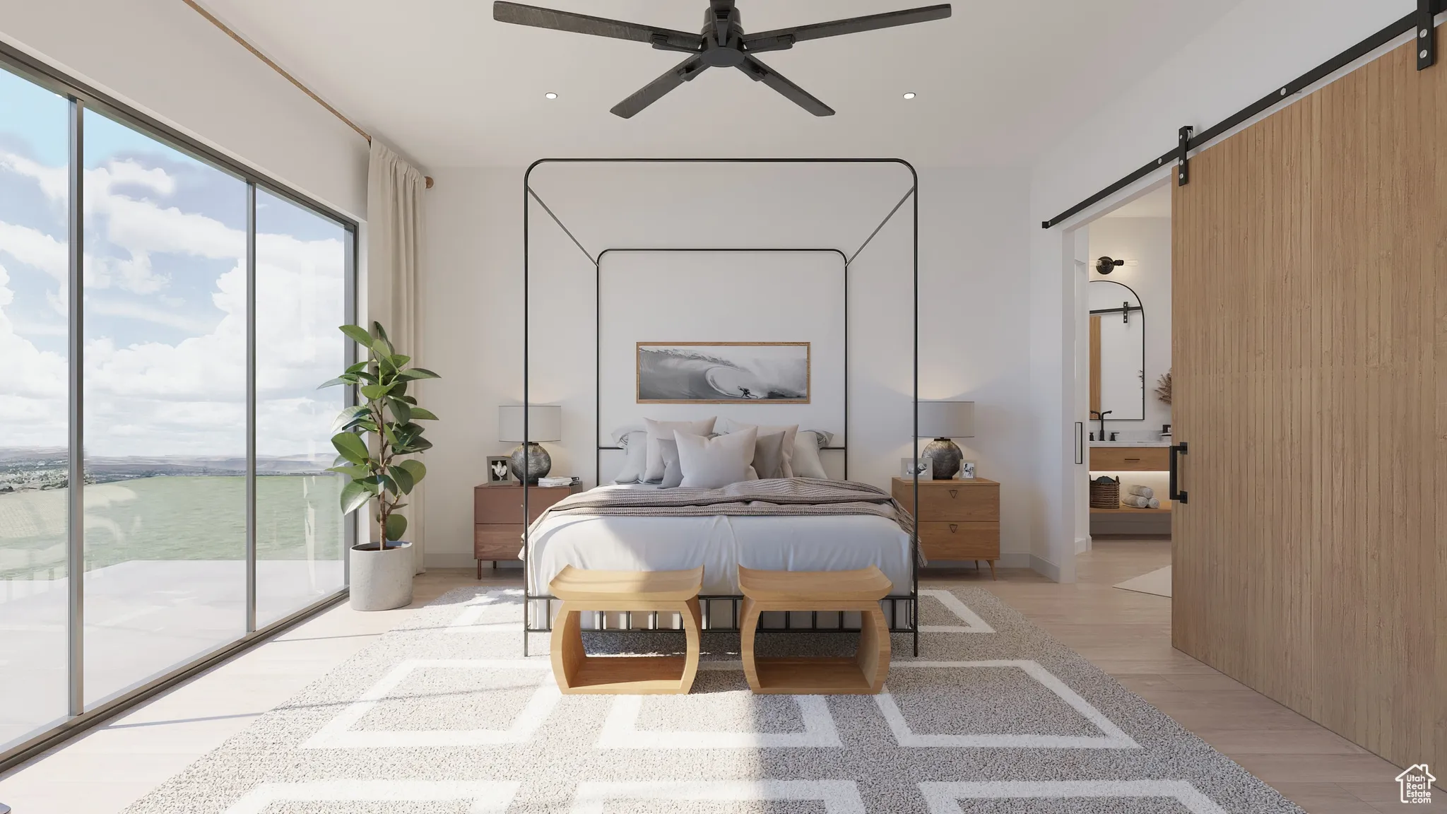 Bedroom with a barn door, light wood-style floors, access to exterior, ensuite bathroom, and recessed lighting